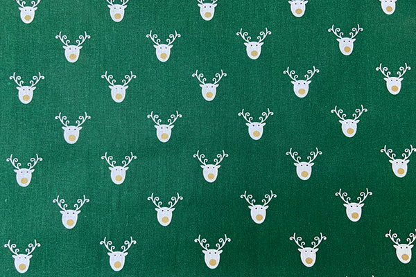 White reindeer head on green 100% cotton print