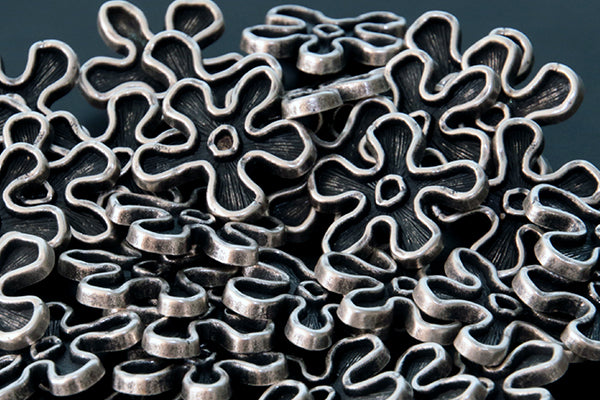 Antique silver & black flower shaped metal shank buttons, rounded petals