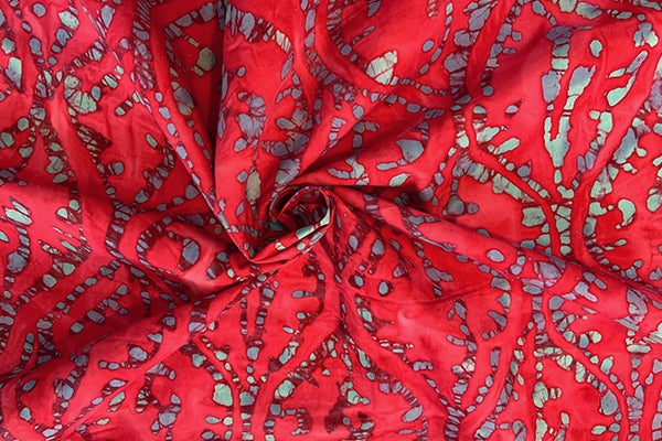 Cerise/Red batik print with teardrop style pattern