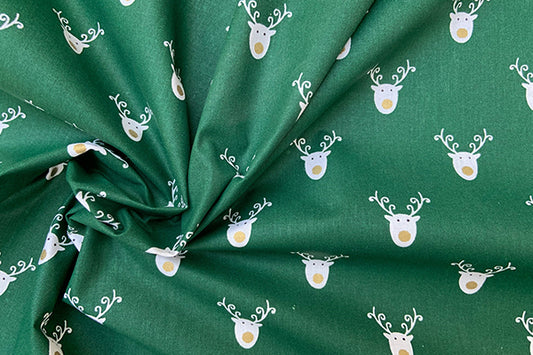 White reindeer head on green 100% cotton print