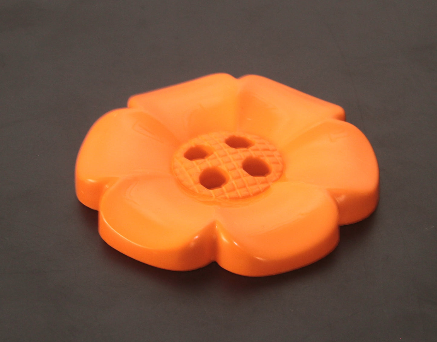 Oversized plastic buttons in flower shape