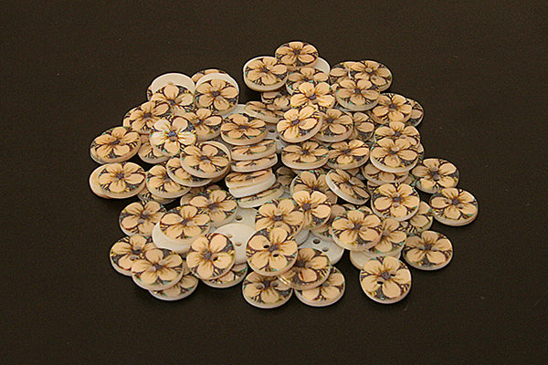 Round mother of pearl button with flower pattern