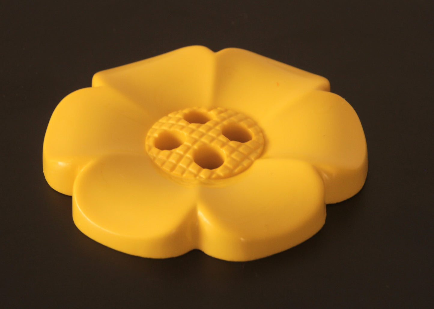 Oversized plastic buttons in flower shape